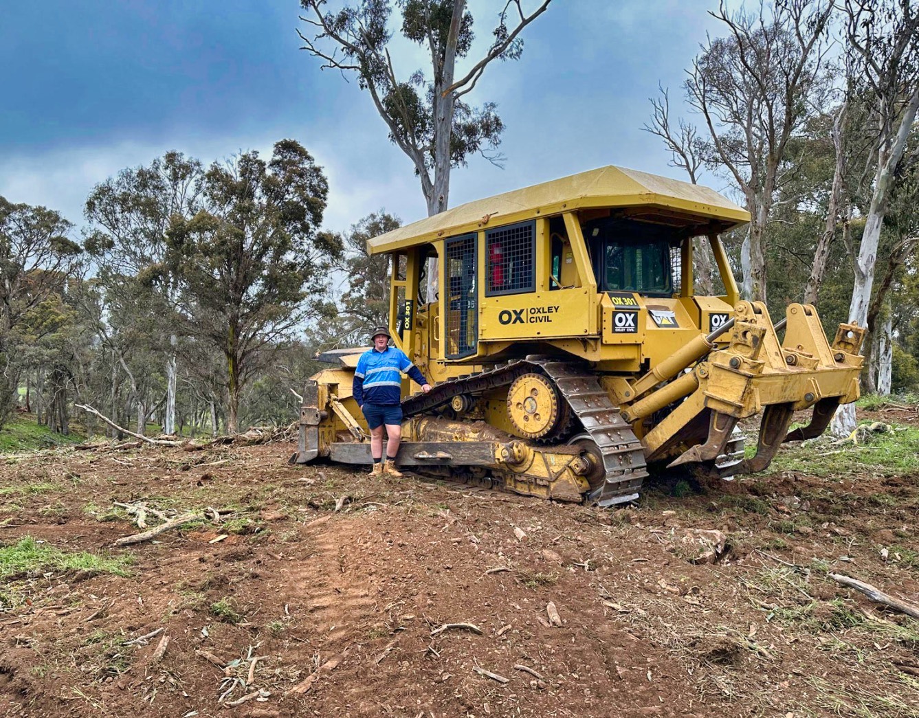 Dozer operator standing beside his machine