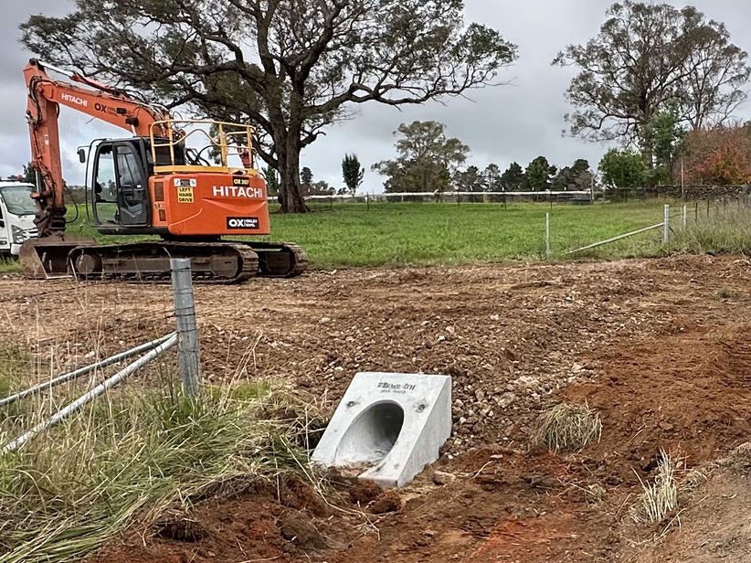 Excavator cutting a table drain