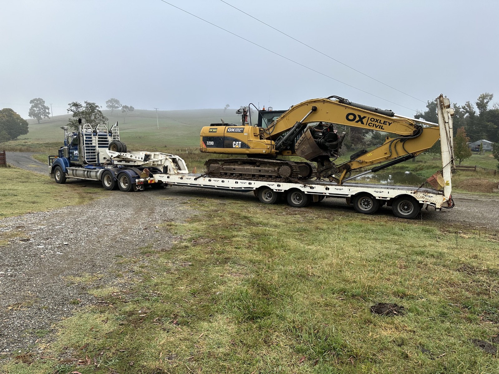 Excavator loaded on a float