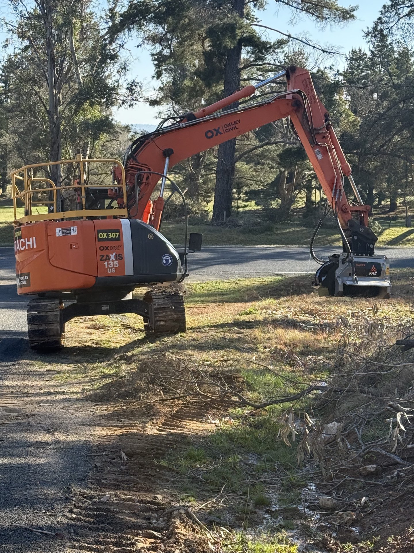 Excavator mulcher working a roadside