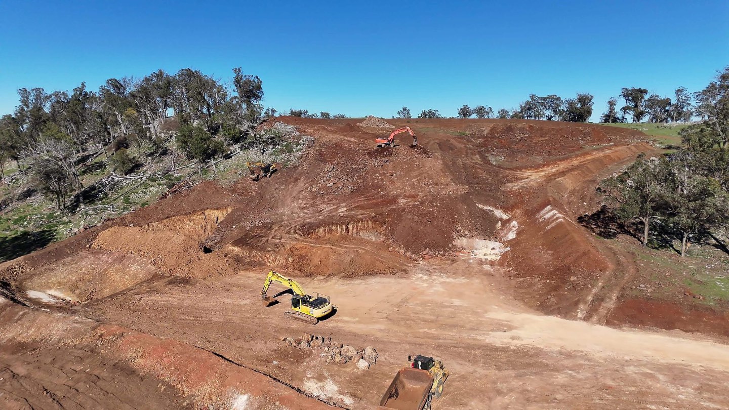Excavator loading a dump truck in the pit