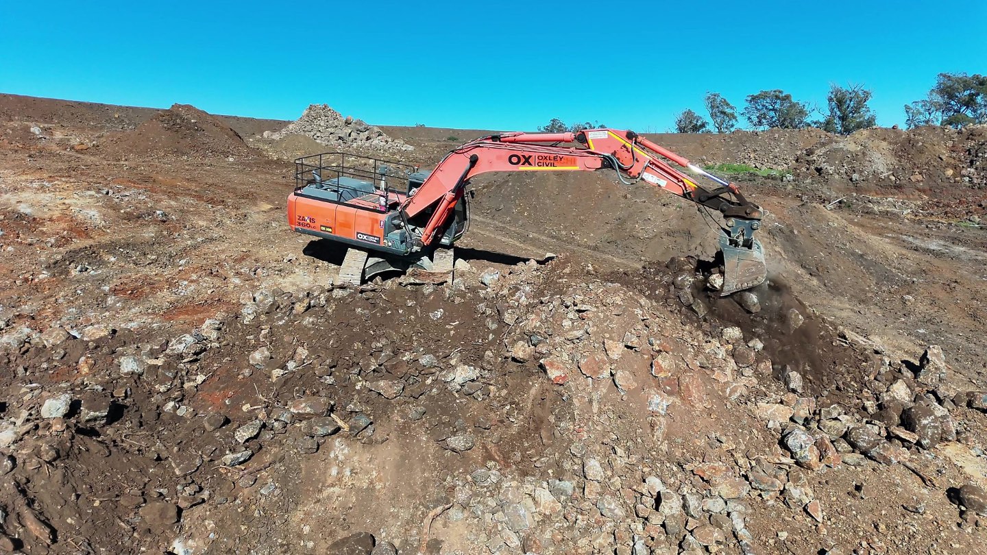 Excavator loading rock