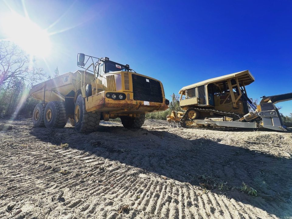 Articulated dump truck and dozer on a rural site