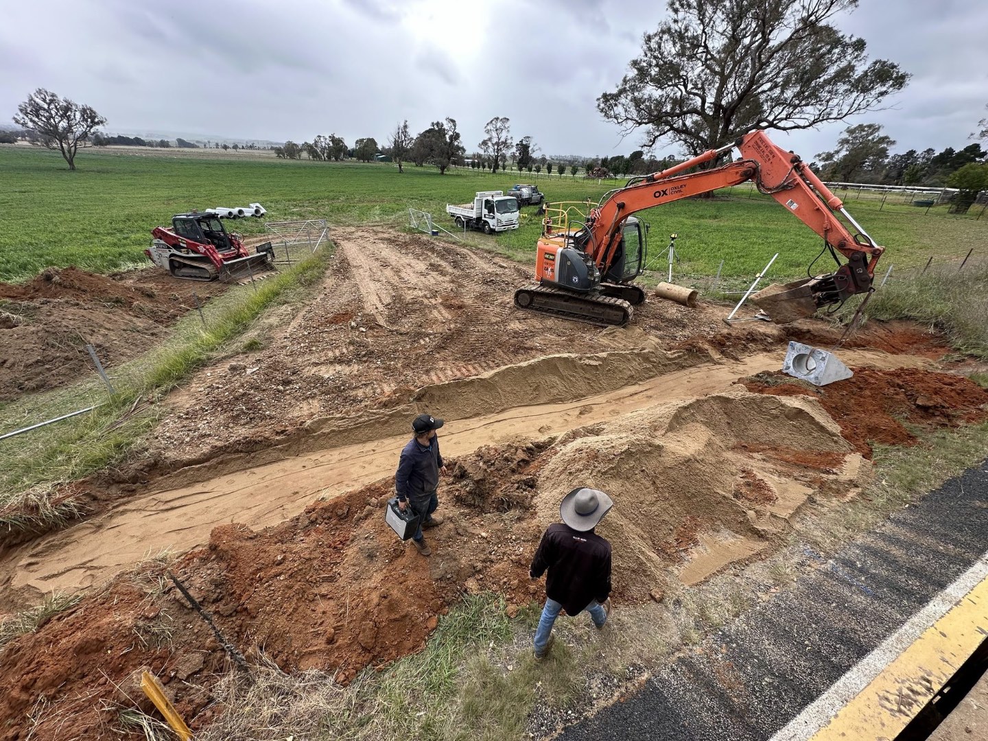 Crew setting out a culvert trench