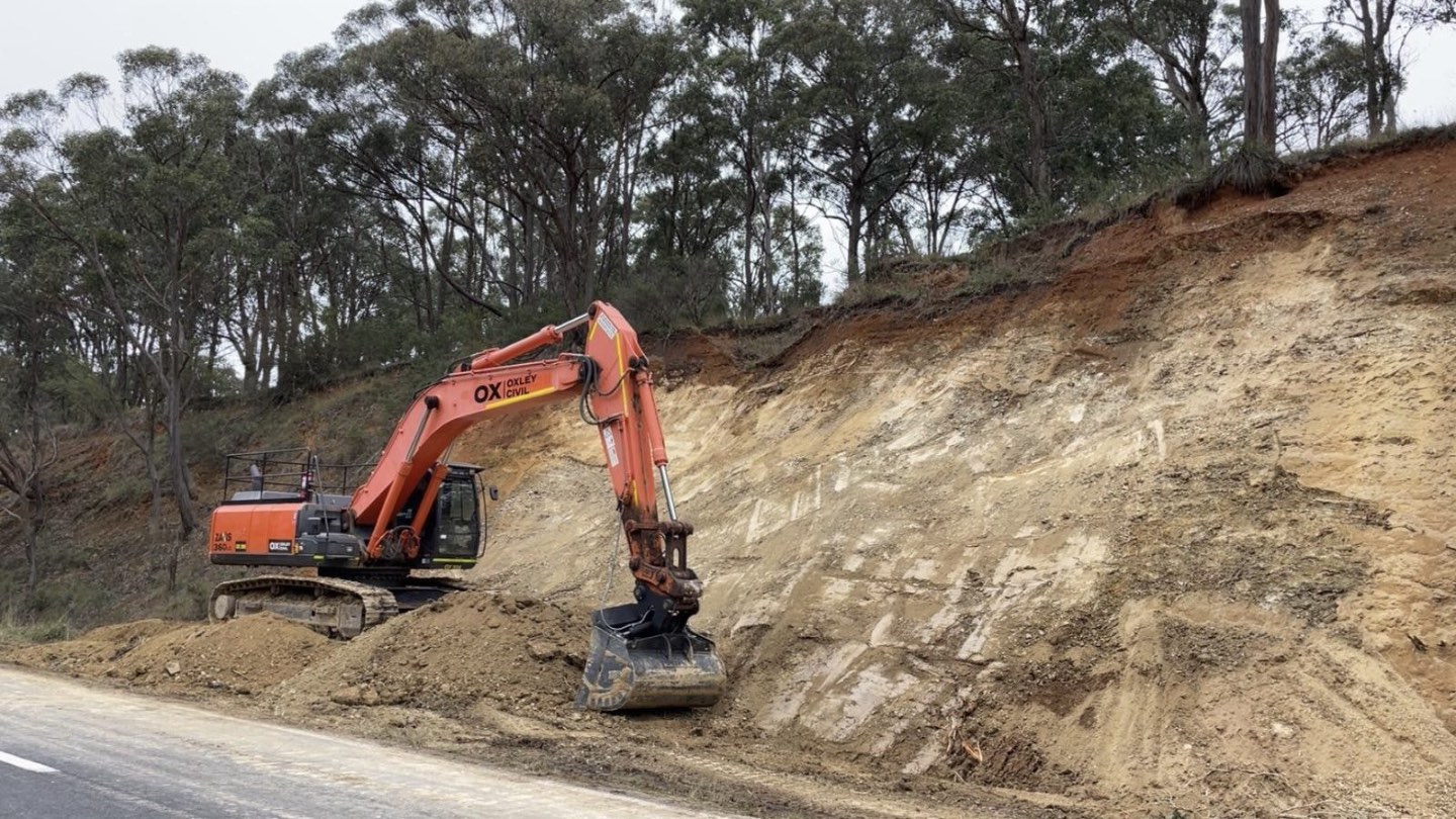 Excavator at the toe of the cutting