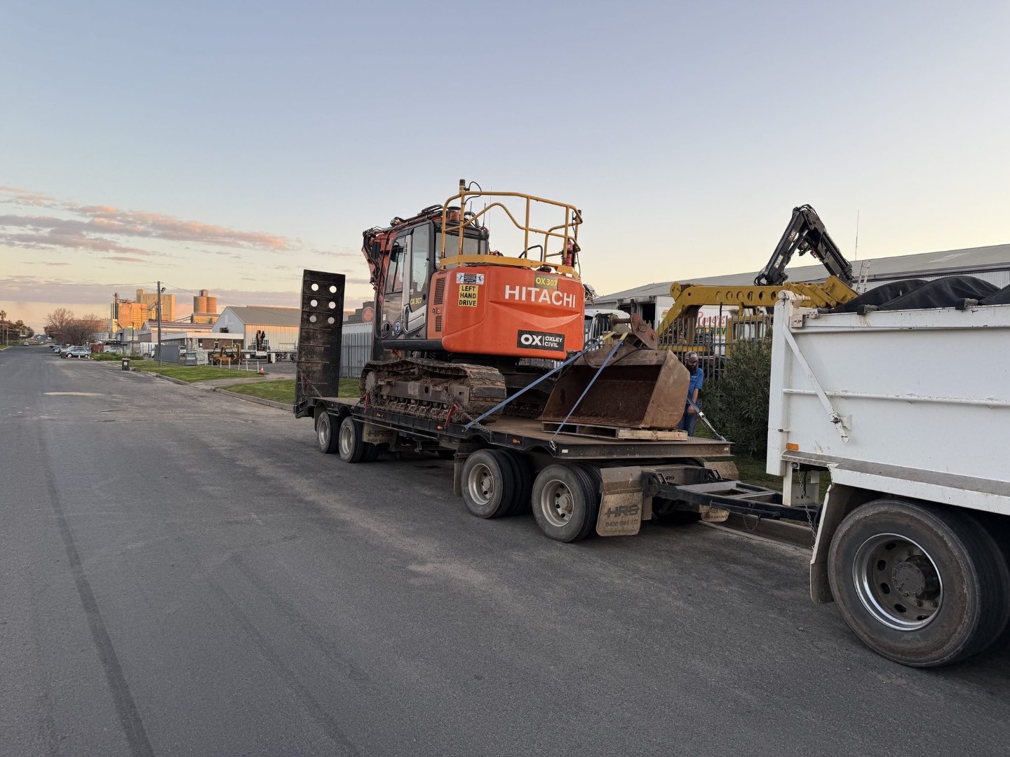 Excavator loaded on the float at dusk