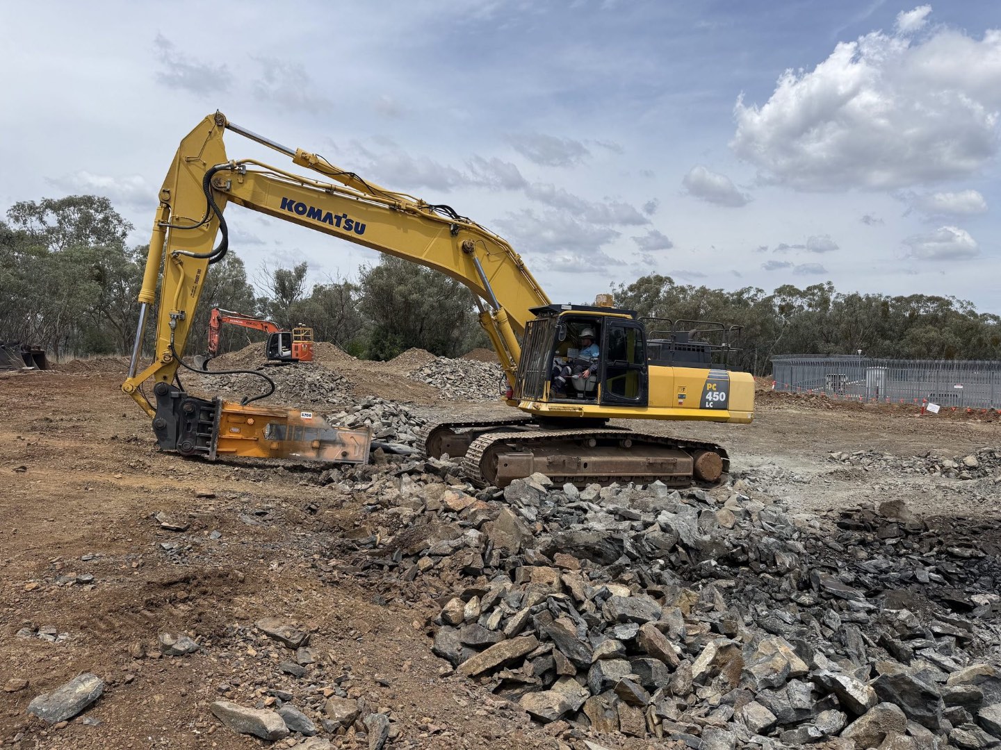 Komatsu PC450 with breaker working rock