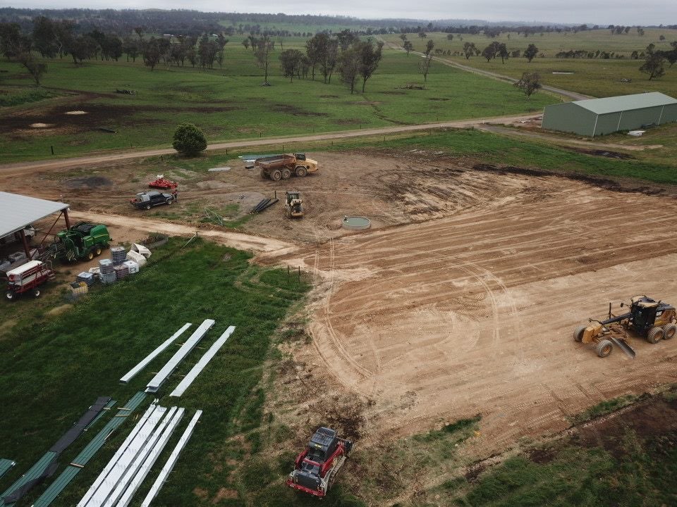 Grader shaping the building pad