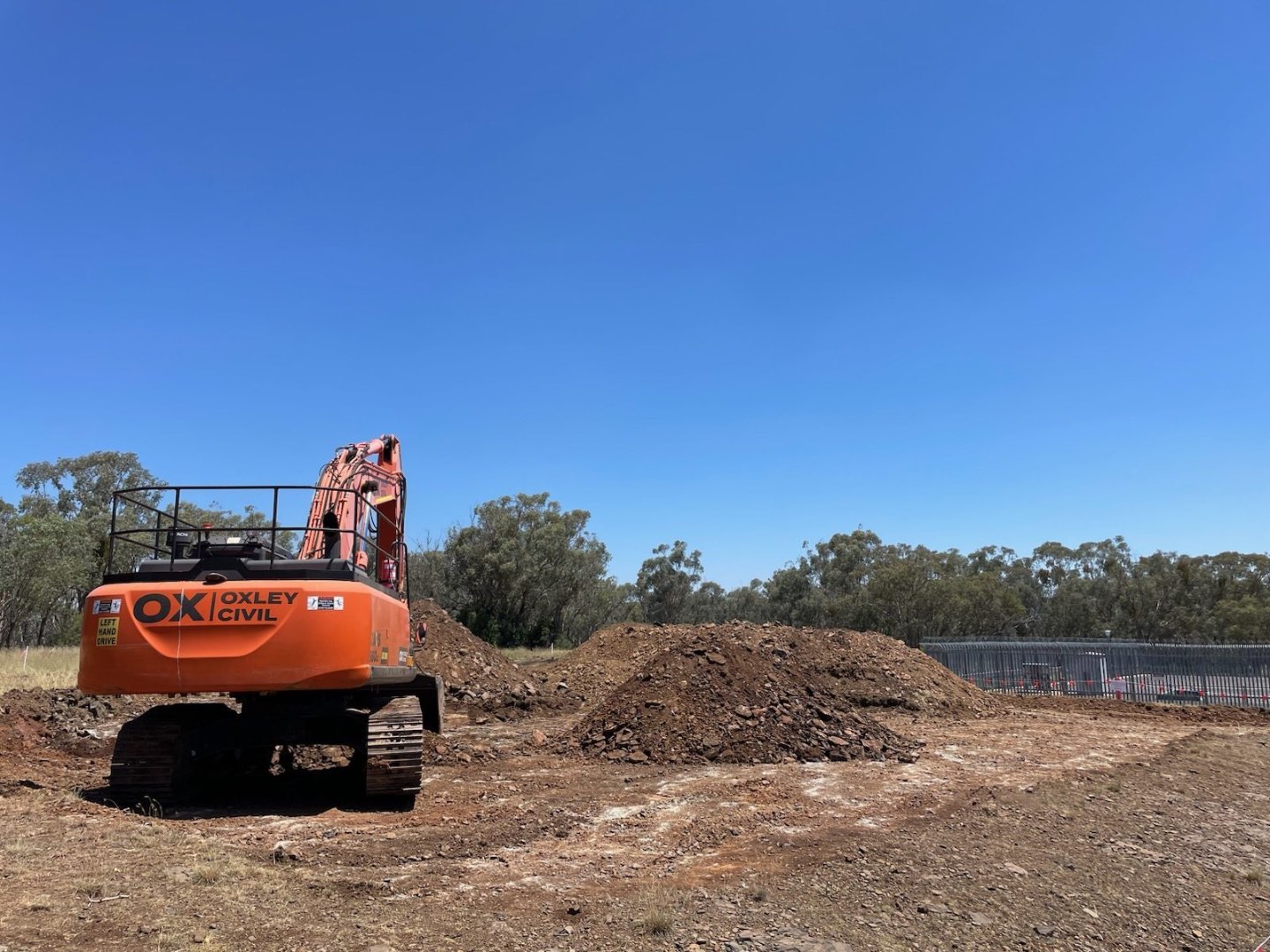 Excavator beside a spoil stockpile